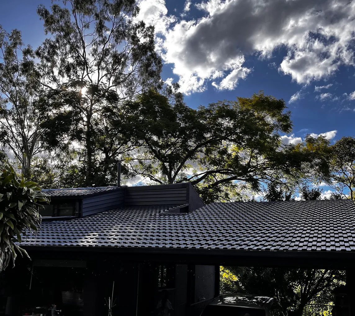 Restored charcoal roof against a blue sky