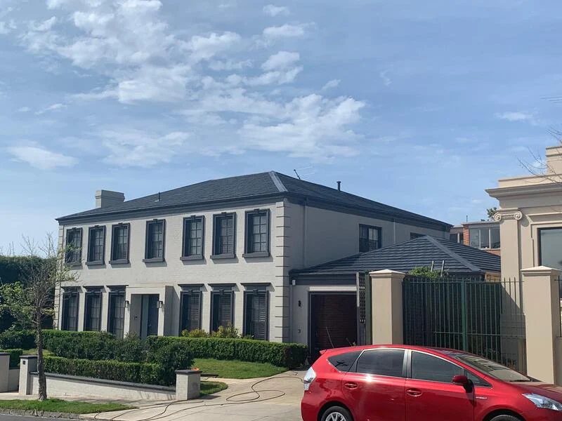Two storey home with newly restored dark roof